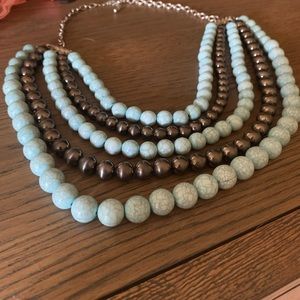 Multi-strand beaded necklace in one
